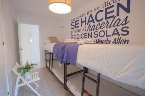 a bedroom with a bed with a sign on the wall at Rural apartment in the mountains in Panticosa