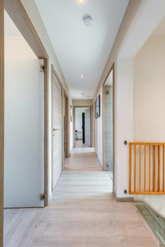 a hallway of a house with white walls and wooden floors at Huswell - Spacious house with garden and parking in Blankenberge
