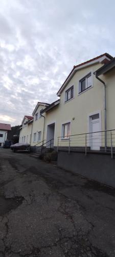 a row of white buildings in a parking lot at Apartmán 10 in Županovice