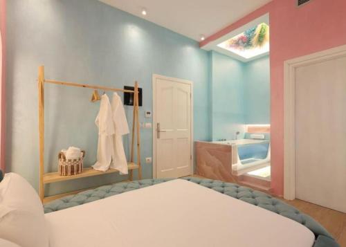 a bedroom with a bed and a bathroom with a tub at Foga Hebrus in Ksamil