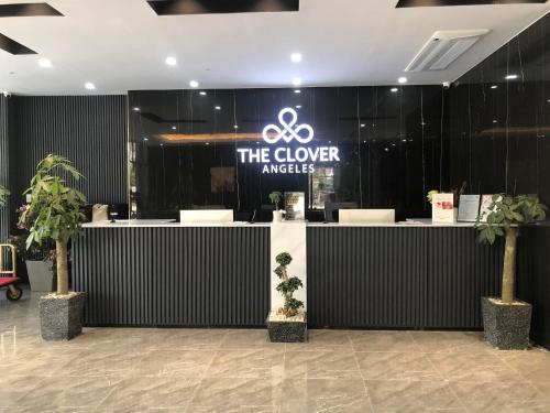 a sign that says the clover awards in a lobby at The Clover Hotel Angeles City in Angeles