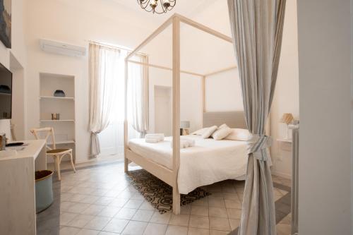 a bedroom with a canopy bed in a room at Il Covo di Monopoli in Monopoli