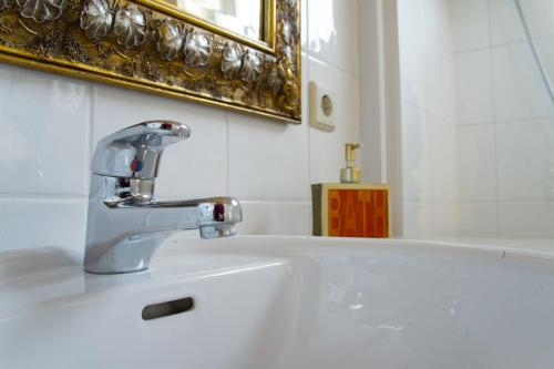 a bathroom with a sink and a faucet at Hotel Grüner Jäger in Jesteburg