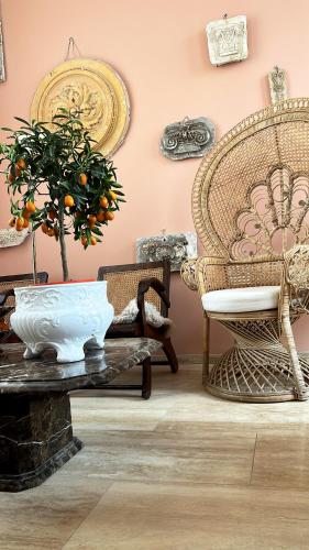 a room with a table with a plant and chairs at Maison Georges in Tourcoing
