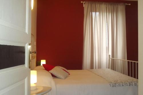 a bedroom with a white bed and a window at B&B Il Tempo Del Vento in front of the Castle in Tresana
