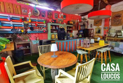 a restaurant with tables and chairs in a room at Caravan of Love by Casa das Artes in Luz de Tavira