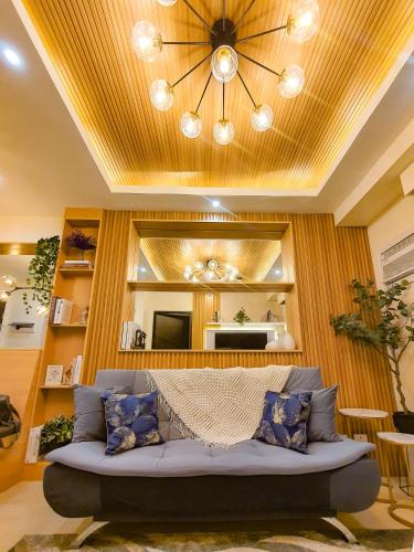 a living room with a couch and a large mirror at The Luxury Lounge in Bacolod