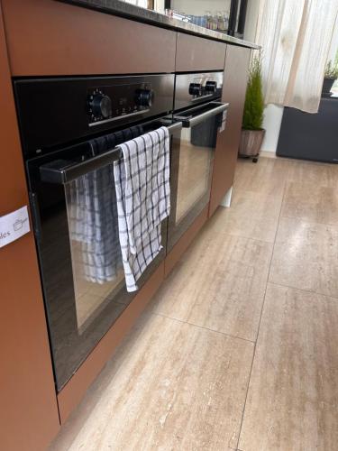 a kitchen with an oven with towels hanging on it at Maison Georges in Tourcoing