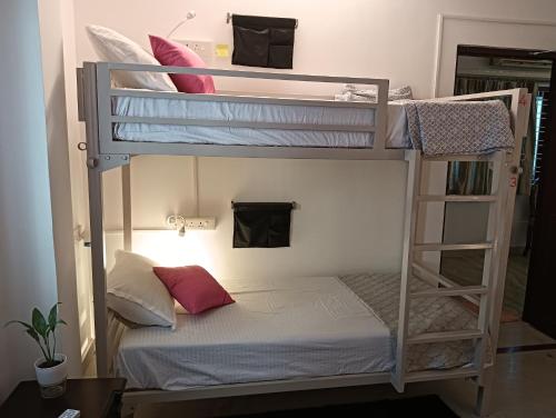 two bunk beds in a room with a bed at Bonjour Travellers Hostel in Hyderabad