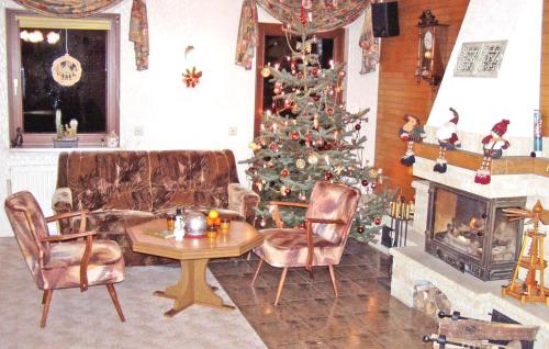 a living room with a christmas tree and a fireplace at Ferienwohnung Altenberg in Bärenstein