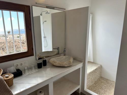 een badkamer met een wastafel en een spiegel bij CASABAH bed & breakfast in Carboneras