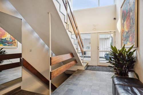 a staircase in a house with paintings on the walls at BB-Hotel Frederikshavn Turisthotellet in Frederikshavn