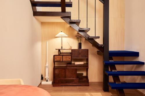 a room with a wooden staircase with a blue rail at anchorAsakusa Vacation Rental in Tokyo