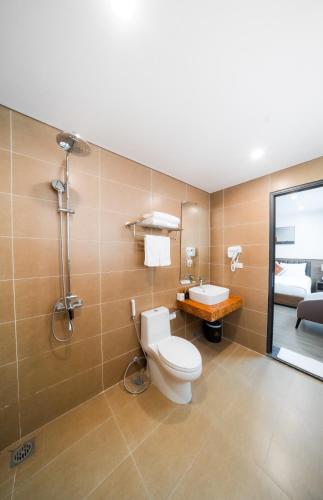 a bathroom with a toilet and a shower and a sink at Lam Anh Hotel 6 Ngoại Giao Đoàn BT4-10 in Hanoi