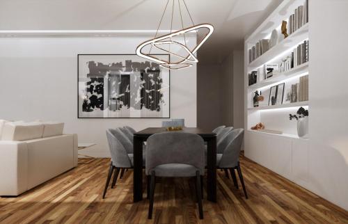 a dining room with a black table and chairs at Luxury River View 3BR with Pool by Airport in Lisbon
