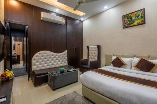 a hotel room with a bed and a chair at Shree Jee Hotel - NIT Faridabad in Faridabad