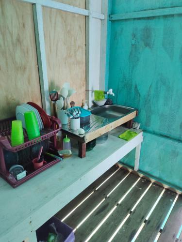 a table with dishes and other items on it in a room at Selambak Homestay in Tarempah