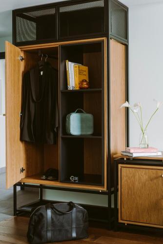 a wooden cabinet with glass doors in a room at PURO Hotel Poznań Stare Miasto in Poznań