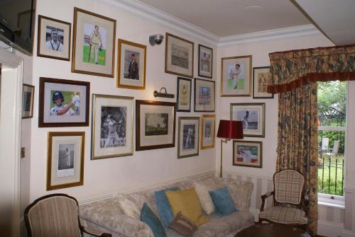 a living room with a couch and pictures on the wall at Haley's Hotel in Leeds