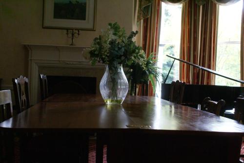 a vase of flowers sitting on top of a table at Haley's Hotel in Leeds