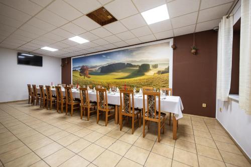 a conference room with a long table and chairs at Penzión Esprit in Sučany