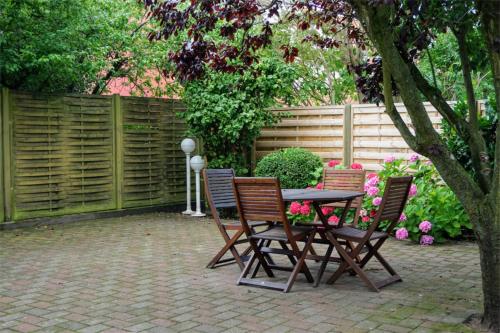 a patio with a table and chairs and a fence at BB-Hotel Frederikshavn Turisthotellet in Frederikshavn