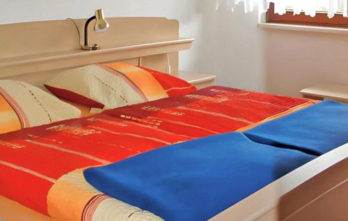 a bed with a colorful blanket on top of it at Beautiful Apartment In Altenberg With Wifi in Bärenstein