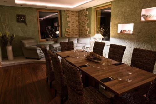 a dining room with a table and chairs and a couch at Relax Vila se zahradním wellness in Ostrava