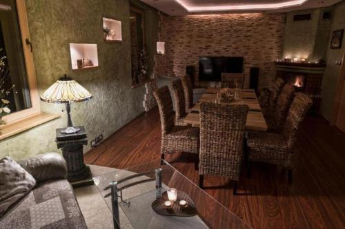 a dining room with a table and chairs at Relax Vila se zahradním wellness in Ostrava