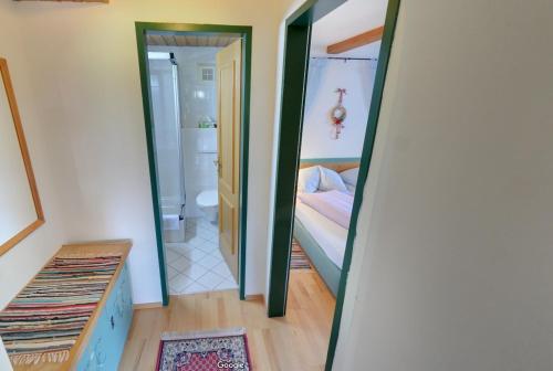 a mirror in a room with a bed and a bathroom at Apartmentpension Hillebrand in Kitzbühel
