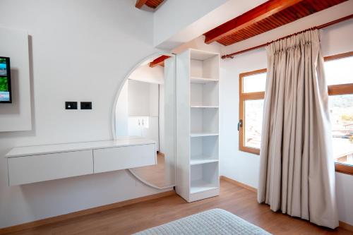a room with a dressing table and a window at Fabio Guest House in Gjirokastër