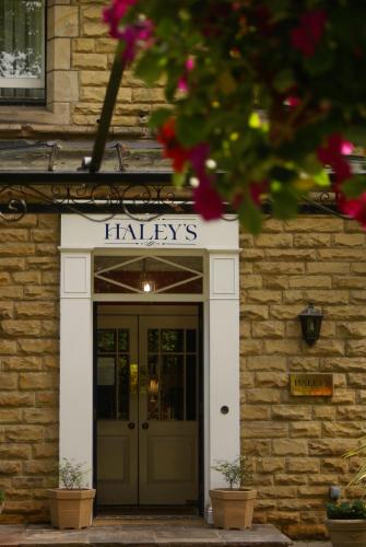 a entrance to a building with a sign above a door at Haley's Hotel in Leeds