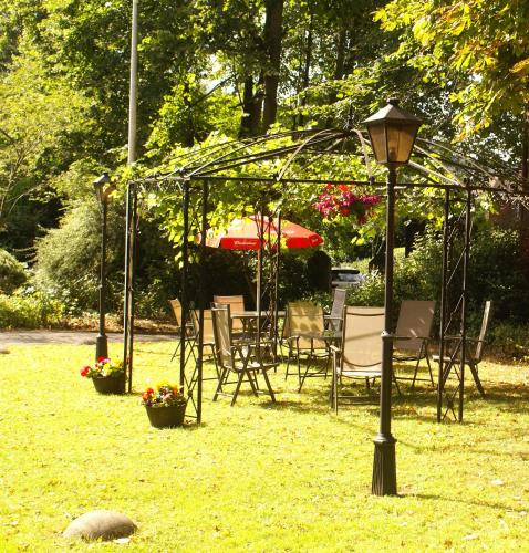 a group of chairs and a tent in the grass at Haley's Hotel in Leeds