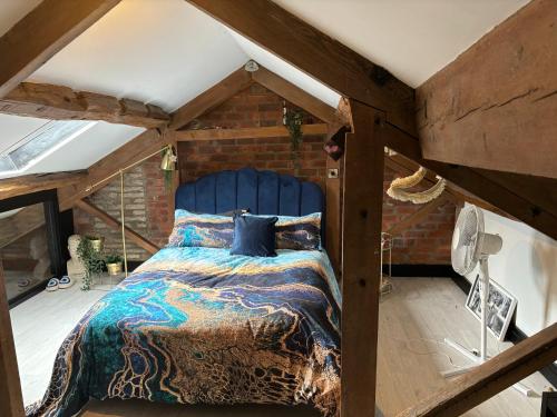 a bedroom with a large bed in a attic at The Old Telephone Exchange in Huddersfield