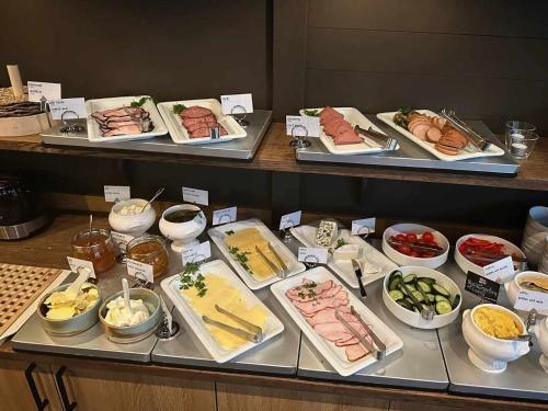 a buffet line with different types of food on trays at Best Western Hotel Trollhattan in Trollhättan