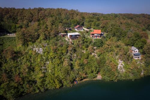 an aerial view of a house on a hill by the water at MREŽNICA - ZELENA BAJKa in Generalski Stol