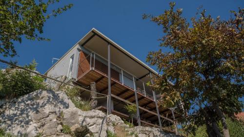 a house on top of a rocky hill at MREŽNICA - ZELENA BAJKa in Generalski Stol