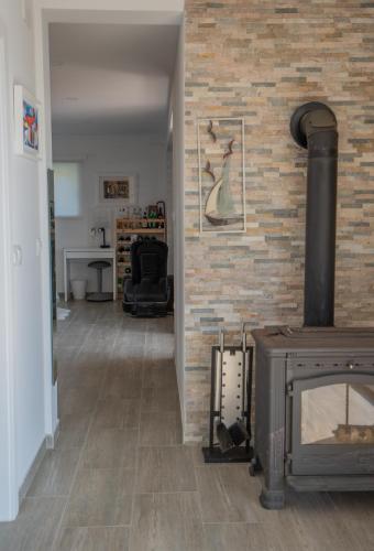 a living room with a fireplace and a brick wall at MREŽNICA - ZELENA BAJKa in Generalski Stol
