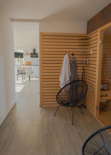 a room with a wooden wall with a table and a chair at MREŽNICA - ZELENA BAJKa in Generalski Stol