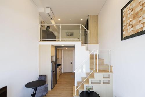 a small apartment with a staircase in the middle of a room at Loft Pool Superior Suite Near jodd Night Market 500mbps Wi-Fi Twin in Ban Wang Sai