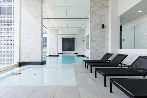 a lobby with a pool in a building at Loft Pool Superior Suite Near jodd Night Market 500mbps Wi-Fi Twin in Bangkok