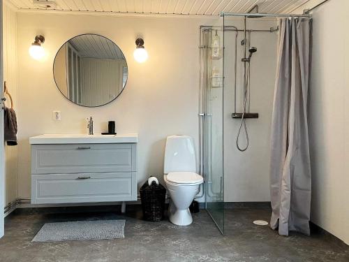 a bathroom with a sink and a toilet and a mirror at 4 star holiday home in Mönsterås-By Traum in Mönsterås