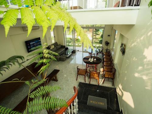 a view of a living room with a table and chairs at Vian Rock Hill Homestay in Hanoi