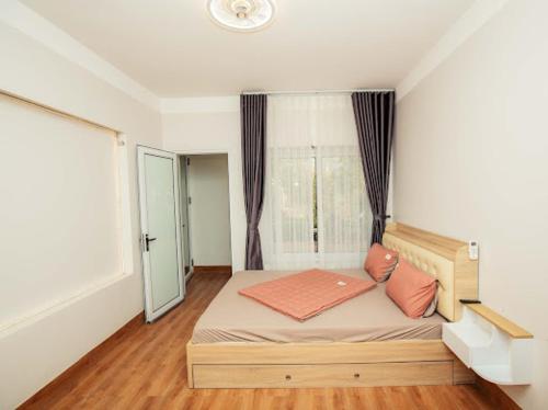 a bedroom with a large bed with a window at Vian Rock Hill Homestay in Hanoi