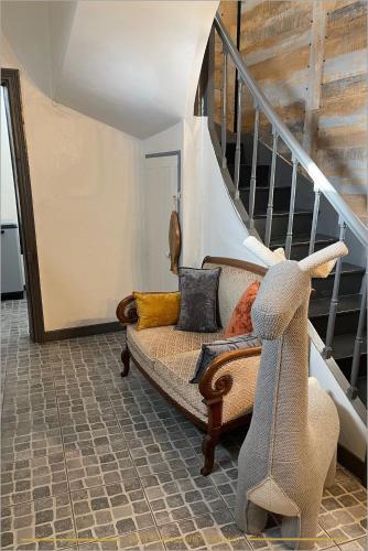 a living room with a couch with pillows on it at Les Apparts 75 & 80 in Châtellerault