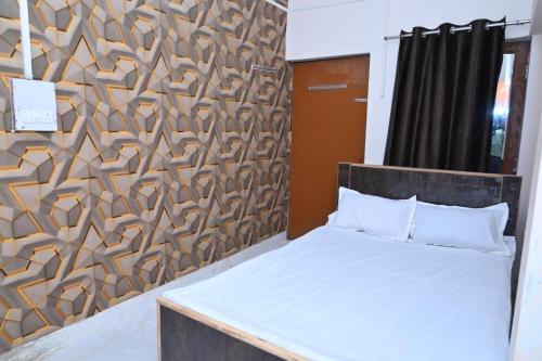 a bedroom with a bed and a wooden wall at Gorakhnath Guest House in Gorakhpur