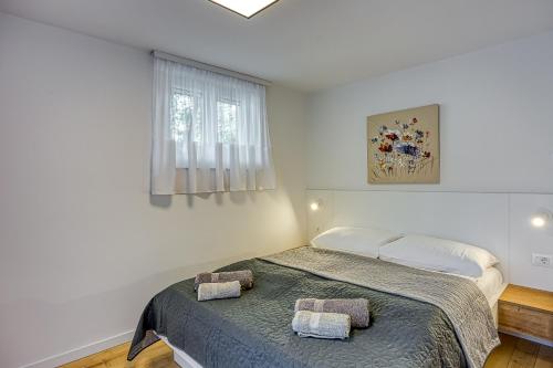 a bedroom with a bed with two towels on it at Apartments Pino in Rovinj