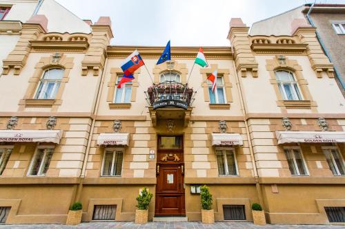 a building with flags in front of it at Golden Royal Boutique Hotel & Spa in Košice