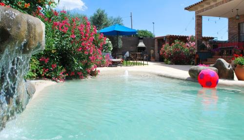 a swimming pool with a soccer ball in a fountain at Casa Rural Dani Escalona in Toledo