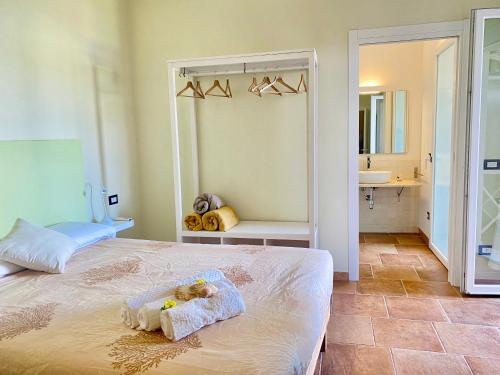 a bedroom with a bed with two teddy bears on it at Domu Su Neulaghe in Villasimius